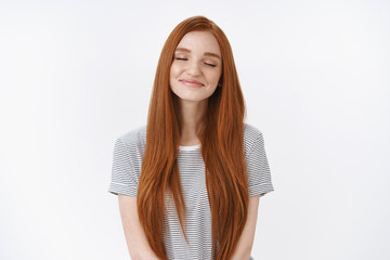 Waist-up shot dreamy romantic charming smiling relaxed redhead girl closed eyes tender delighted smile imagine perfect lovely moment daydreaming making wish recalling nice memory, white background