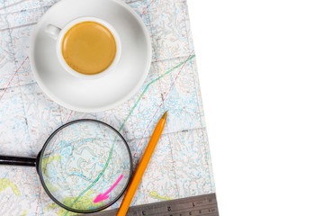 Map of the area with coffee, magnifying glass, ruler and pen, planning new routes, concept.