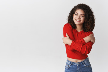 Charming young smiling friendly-looking lively happy girl feeling little chilly windy evening...