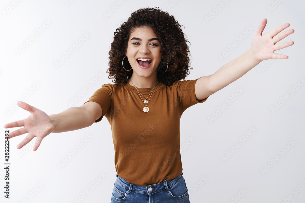 Wall mural excited happy attractive stylish modern girl welcoming best friend spread arms sideways cuddle wanna