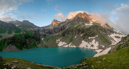 Naklejka na ściany i meble Alpine lake Klukhor with beautiful water and surrounded by mountains in the Caucasus in the Karachay-Cherkess Republic