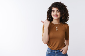 Have you met my friend. Glad good-looking confident stylish female curly dark hair pointing thumb...