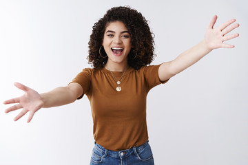 Excited happy attractive stylish modern girl welcoming best friend spread arms sideways cuddle...