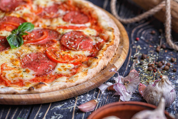 Tender pizza with sausage, tomatoes and cheese