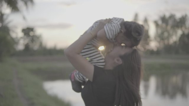 Asian moms and daughters are playing in the outdoor fun at sunset. happily, Slog3