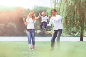 happy mother,father and son on a walk Sunny day