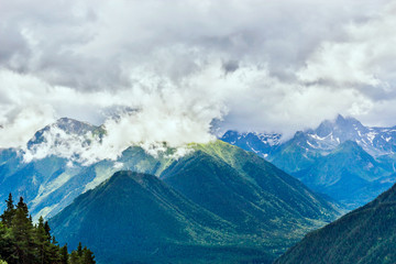 caucasian mountains and cloudy sky on a summer day