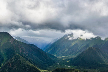 Obraz na płótnie Canvas caucasian mountains and cloudy sky on a summer day
