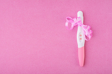 Positive pregnancy test isolated on pink background