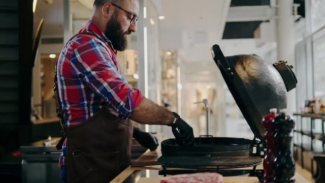 Chef preparing charcoals before grilling in a restaurant