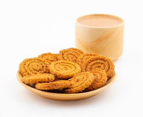 Indian Traditional Tea Time Snack Chakli, a spiral shaped crisp deep fried snack, It is known as  Chakali, Murukku, Muruku, Murkoo, Chakri in Gujarat, Chakli in Maharashtra and Northern India