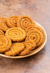 Indian Traditional Snack Chakli, a spiral shaped crisp deep fried snack, It is known as  Chakali, Murukku, Muruku, Murkoo, Chakri in Gujarat, Chakli in Maharashtra and Northern India