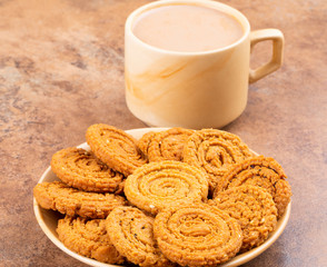 Indian Traditional Tea Time Snack Chakli, a spiral shaped crisp deep fried snack, It is known as  Chakali, Murukku, Muruku, Murkoo, Chakri in Gujarat, Chakli in Maharashtra and Northern India