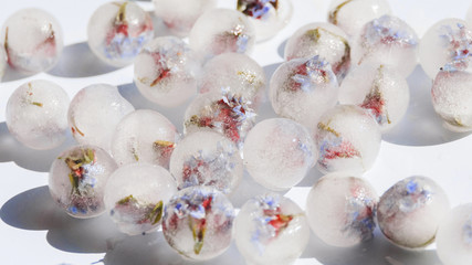 White ice spheres with flowers inside