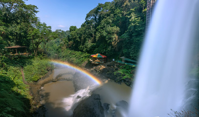 The majestic Dambri Falls near Bao Loc City, Vietnam. The waterfall is over 90m high, pouring into the valley, creating fog and rainbow when the sunshine through