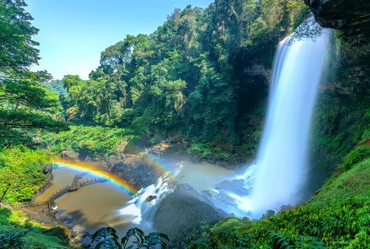 The majestic Dambri Falls near Bao Loc City, Vietnam. The waterfall is over 90m high, pouring into the valley, creating fog and rainbow when the sunshine through