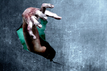 Zombies hands out of broken walls