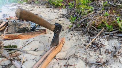 ax in a log near a fire