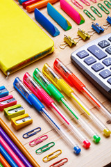 Group of school supplies and notebooks on wooden table