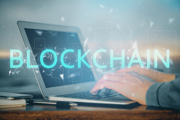 Blockchain theme hud with businessman working on computer on background. Concept of crypto chain....