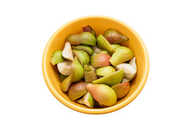 sliced pears in a yellow bowl on a white background, isolate