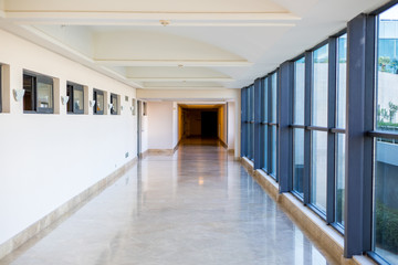 long empty corridor with large glass windows. Modern corridor. Commercial architecture