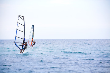 Naklejka premium Windsurfer sailing on a windsurf board. Windsurfing, Sailing, Summer, Water Sports