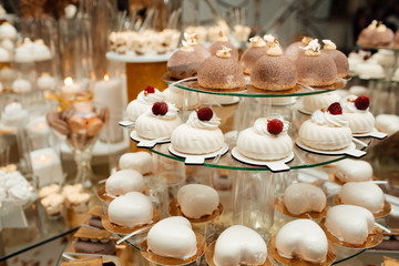 Candy bar with tasty desserts  at wedding reception. Sweet food, dessert, buffet, catering table, restaurant. Beautiful modern decoration sweets on table.
