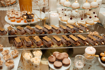Dessert table for a party. Eclairs, cake, cupcakes, sweetness 