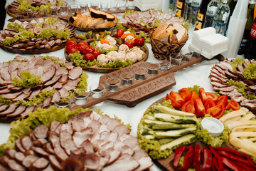 Snacks, fish and meat specialities on the buffet. Desserts. A gala reception. Served tables. Catering.