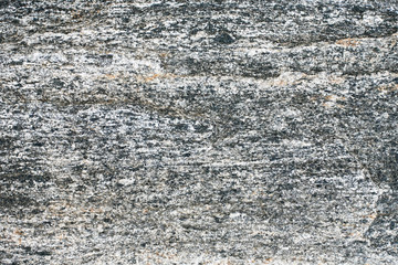 Gray rock mineral background. Cracked stone closeup macro texture. Natural geology pattern.