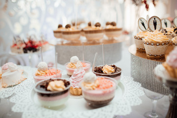 Candy bar. Table with different sweets for party. Sweet table for child birthday. Candy bar with a lot of different candies and sweet cakes