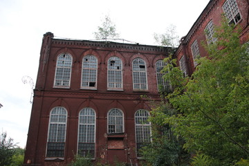 Abandoned red brick old textile fabric in Ivanovo in summer evening light