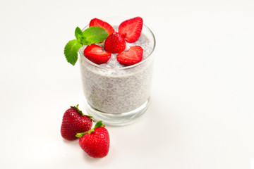 Chia pudding with strawberry and mint on a white background. Space for text or design.