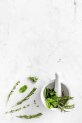 Healing herbs for medicine on white marble background top view mockup