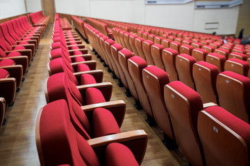 Obraz premium Close-up shot of red chair seats in empty conference room