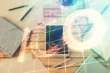 Double exposure of bitcoin drawing on digital tablet on the table background. Concept of blockchain