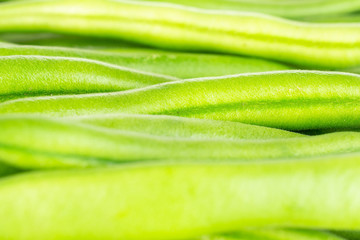 Lot of whole fresh green bean in closeup isolated on white background