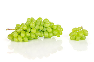 Lot of whole fresh green grape small bunch is aside isolated on white background