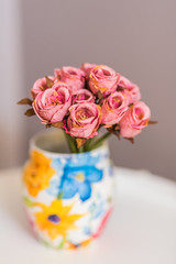 Bouquet of small roses in a vintage vase