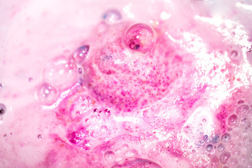 The bright bath bomb dissolves in water .