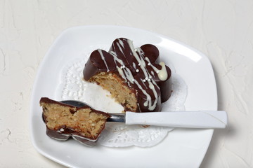 Chocolate dessert in the shape of a flower. Dark chocolate coated. Garnished with white chocolate and sprinkles.