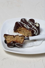 Chocolate dessert in the shape of a flower. Dark chocolate coated. Garnished with white chocolate and sprinkles.