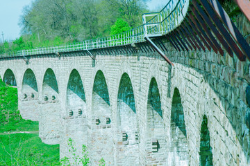 Fragment of antique stone romanesque bridge. Ancient construction, aqueduct.