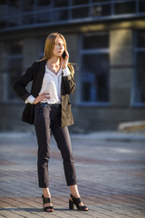 Fototapeta premium Woman talking at phone long shot