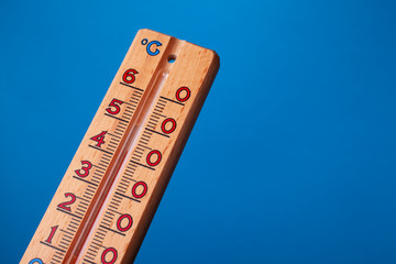 global warming - thermometer close up on blue background