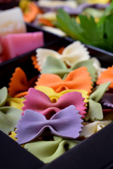 Close-up of multicolored pasta farfalle laid out in a row