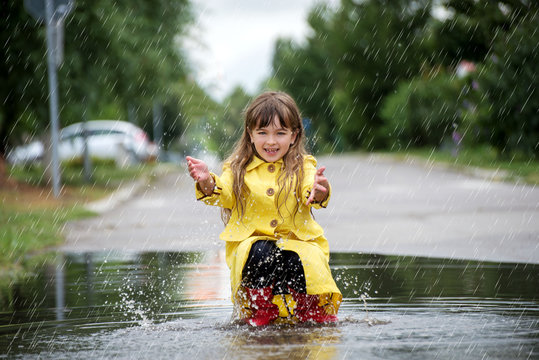 Child under autumn rain  with umbrella