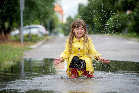 Child under autumn rain  with umbrella