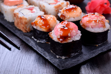 Close-up of sushi roll wrapped in nori with spicy sauce
